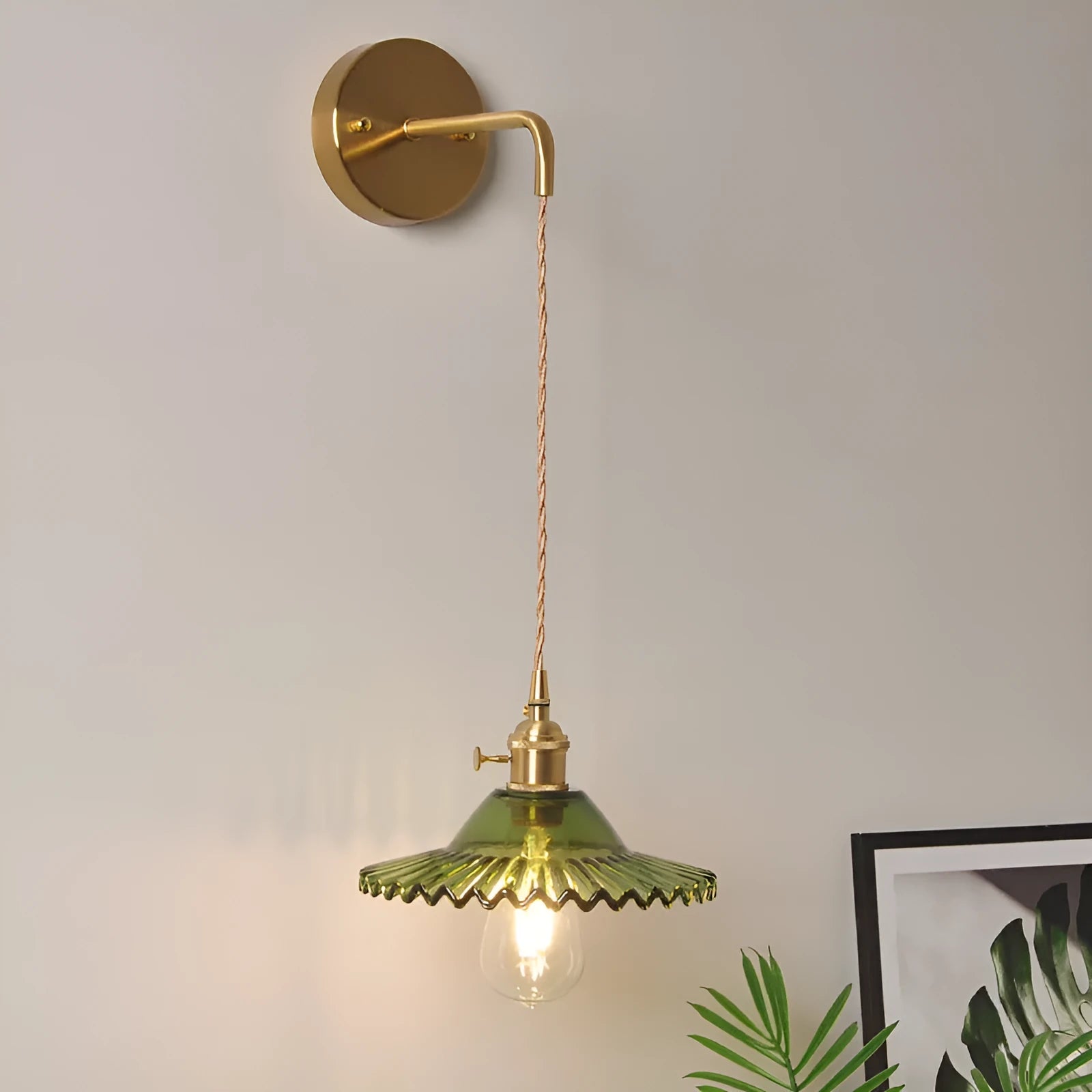 Retro brass wall lamp with lotus-shaped glass shade in choice of colours, mounted on a wall.