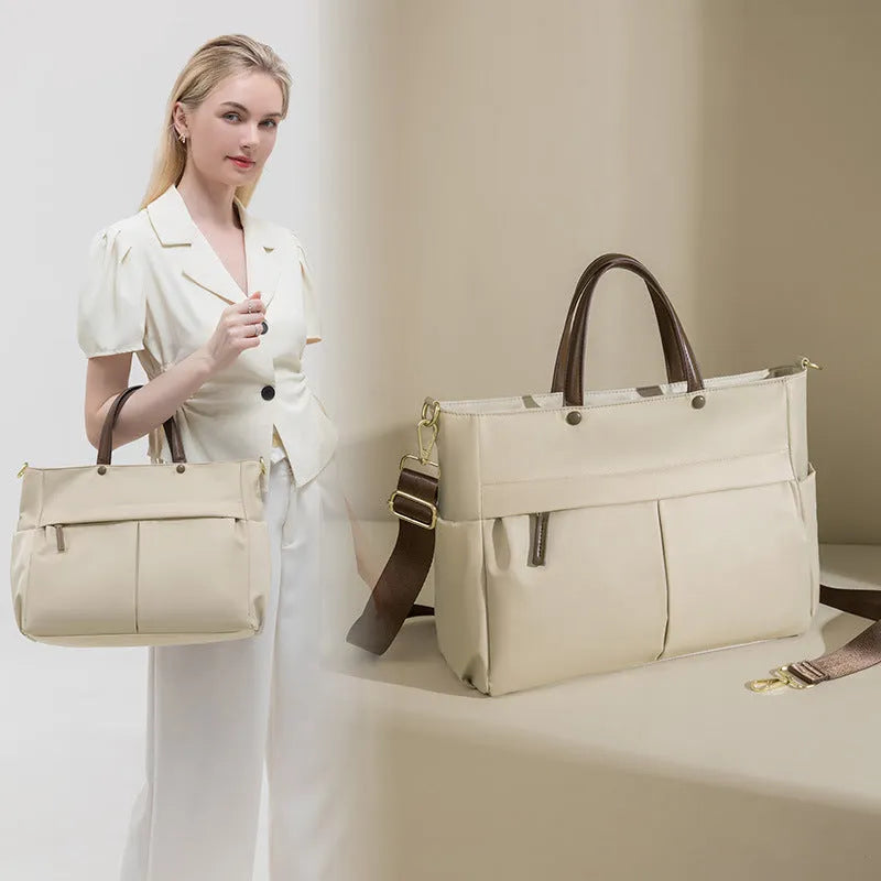 Women's Oxford cloth briefcase with shoulder strap showing open pocket organisation and contrast stitching details
