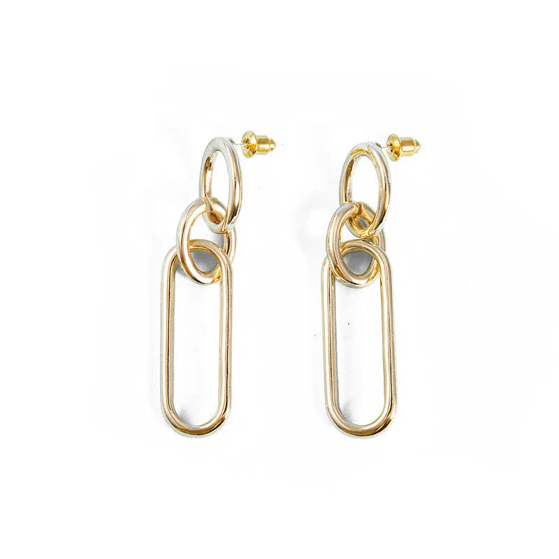 Sterling silver geometric hoop earrings with ring and line design on silver background