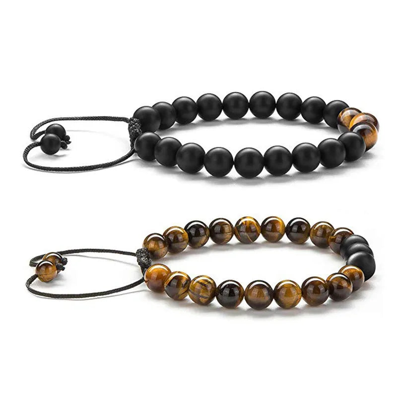 Matte black agate tiger eye bead couple bracelets with geometric design on a neutral background.