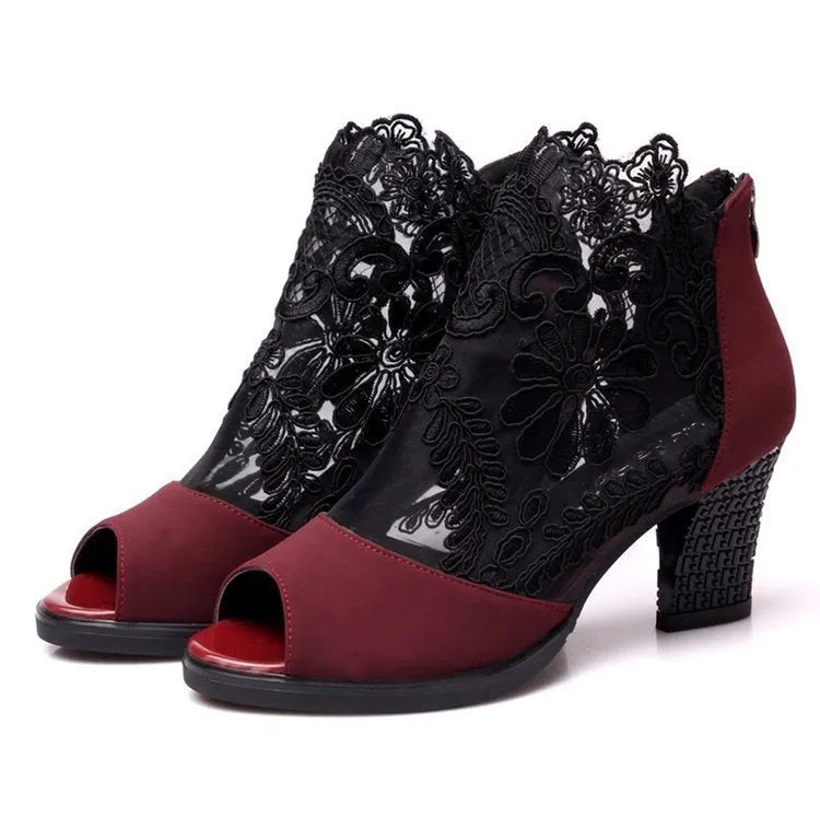 Women's black gladiator sandals with square heels and flower lace upper showing zip closure detail