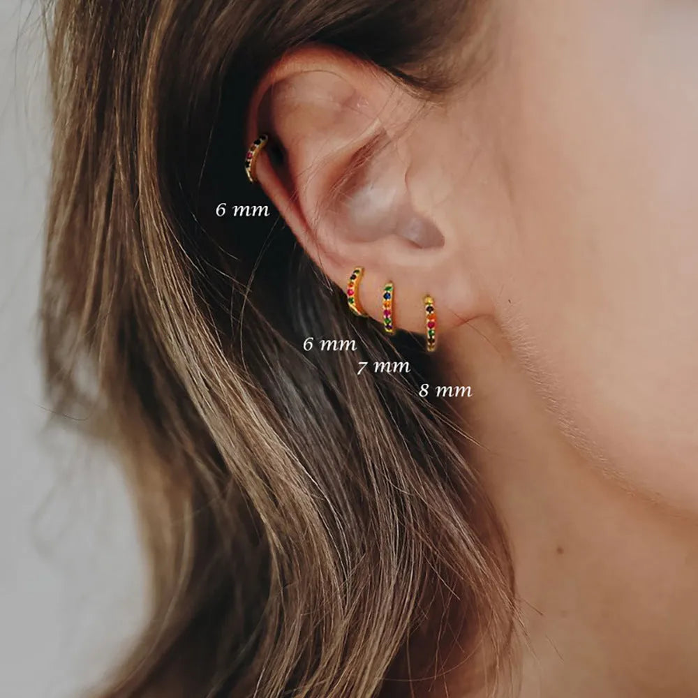 Perforated circle zircon stud earrings in gold, rose gold, or silver colour on white background