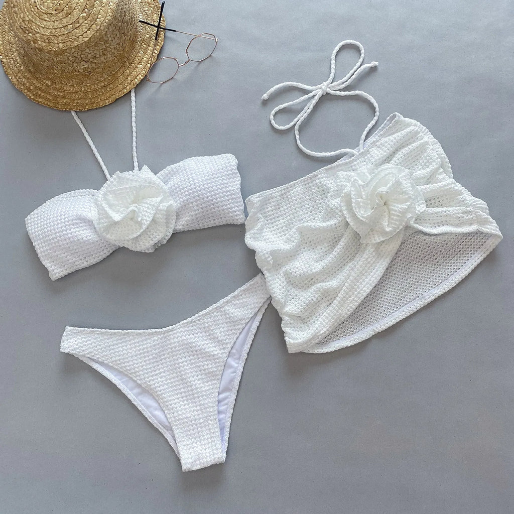 Women's purple and white 3D flower split three-piece bikini set with bra, panties, and skirt.