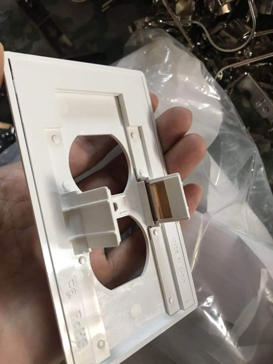 White plug-in LED sensor night light installed in a wall socket