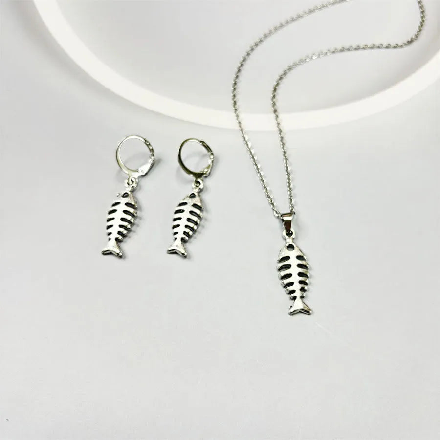 Silver-colour fishbone pendant necklace with O-chain and matching earrings on grey background