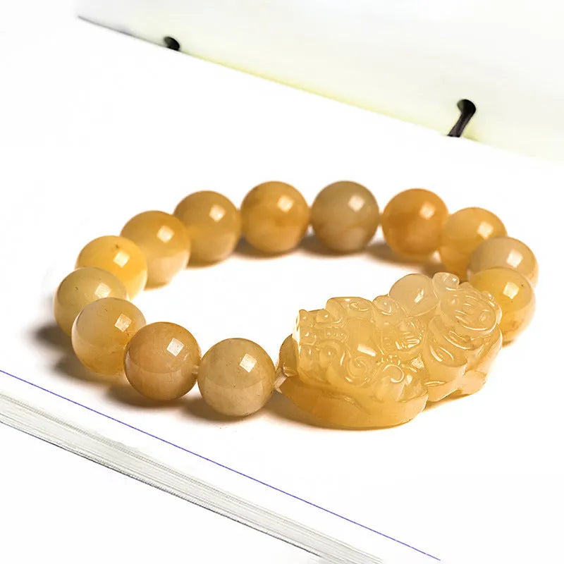 Golden Thread Jinsi Jade money bracelet with carved beads in two size options.
