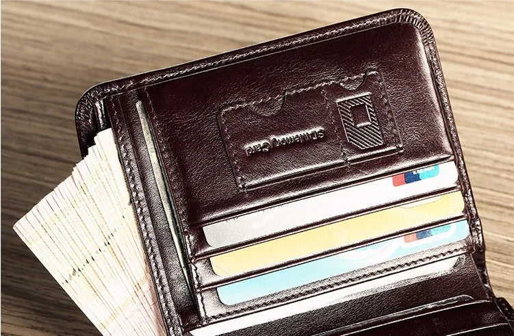 Men's brown leather bifold wallet open to show internal card slots, coin pocket, and photo holder.