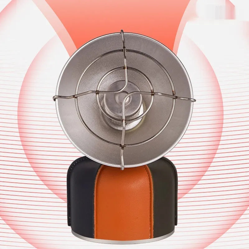 Black and orange mini portable outdoor heating stove with automatic ignition on a table.