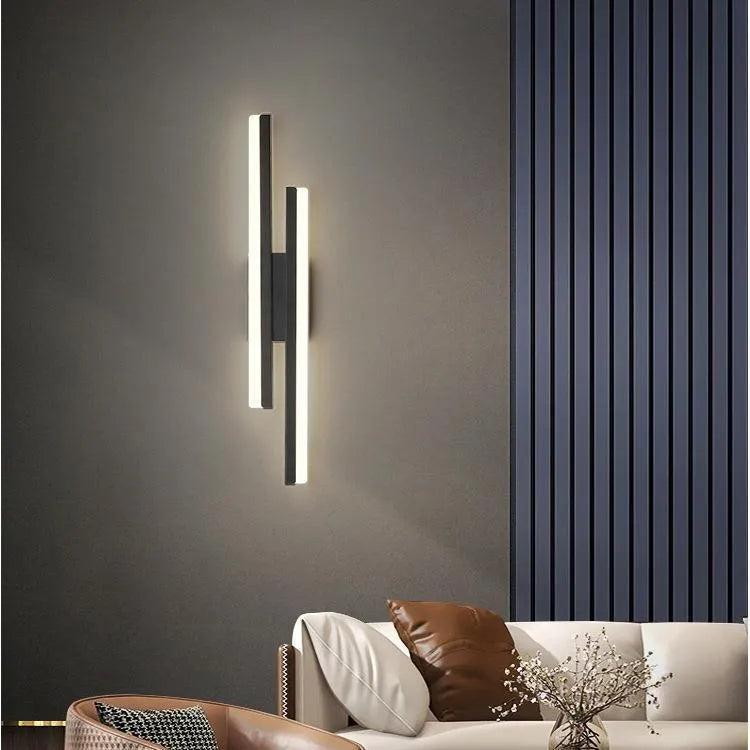 Scandinavian minimalist LED wall light with acrylic shade on black or gold arm.