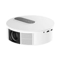 White HD home projector with remote control on a table.