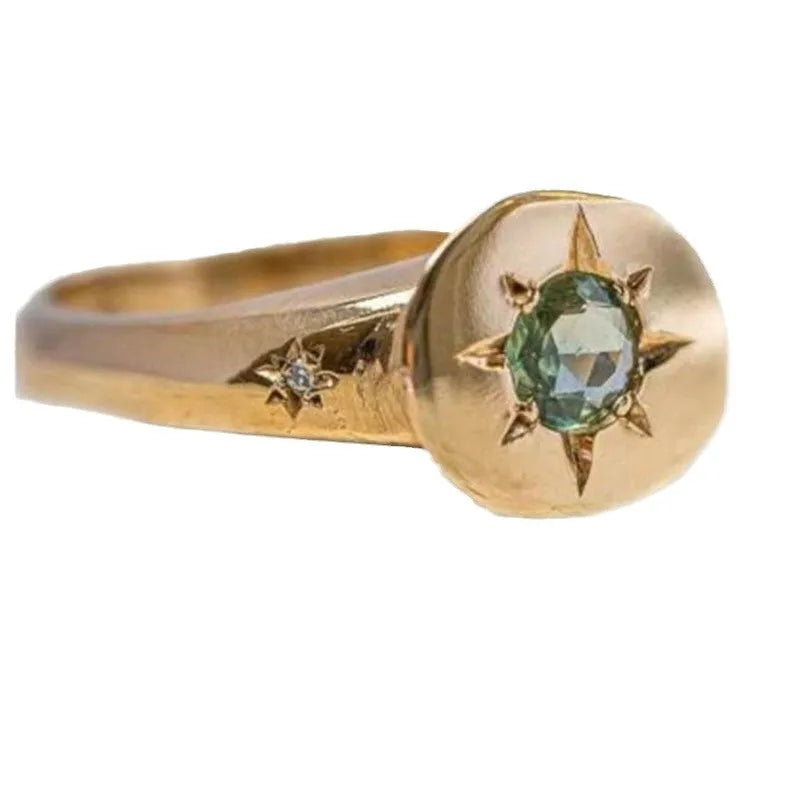 Gold ring with star-shaped asterism pattern and adjustable opening.