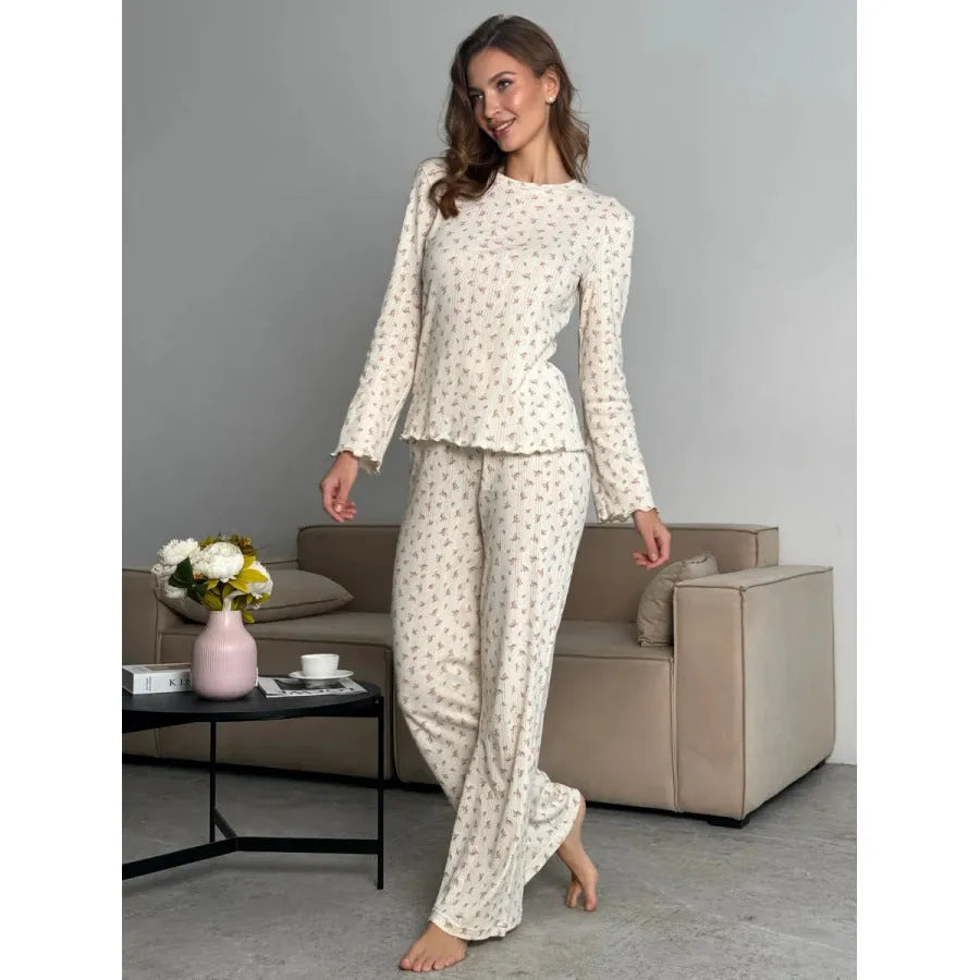 White floral print women's sleepwear set with long bell sleeve top and wide-leg trousers.
