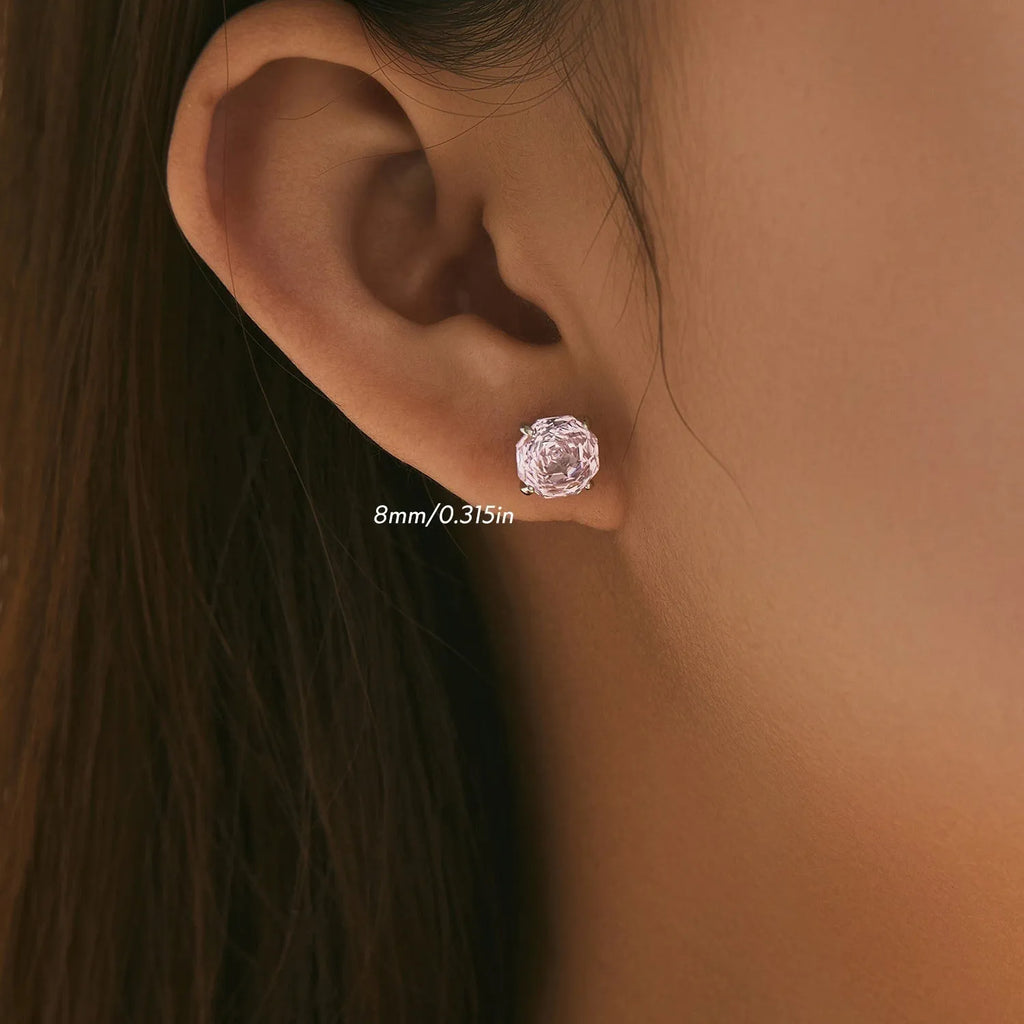 Close-up of pink rose-shaped stud earrings made from S925 sterling silver, shown on a plain background.