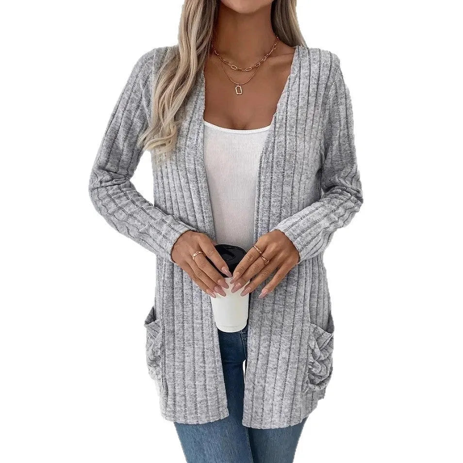 A woman's loose-fit long sleeve cardigan in Grandad Grey with pockets, shown on a hanger.