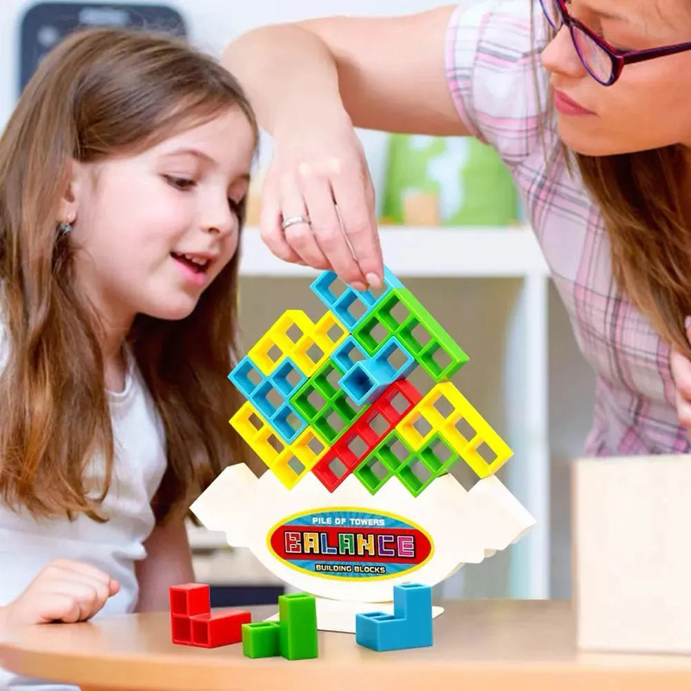 Plastic balance stacking game with 16 coloured building blocks on chassis