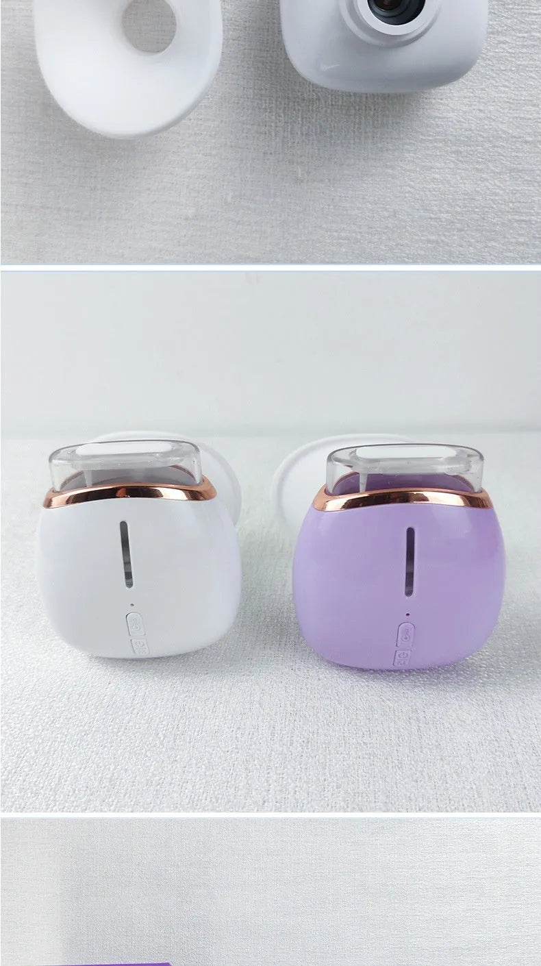 White and purple household eye humidifier with charging cable on desktop