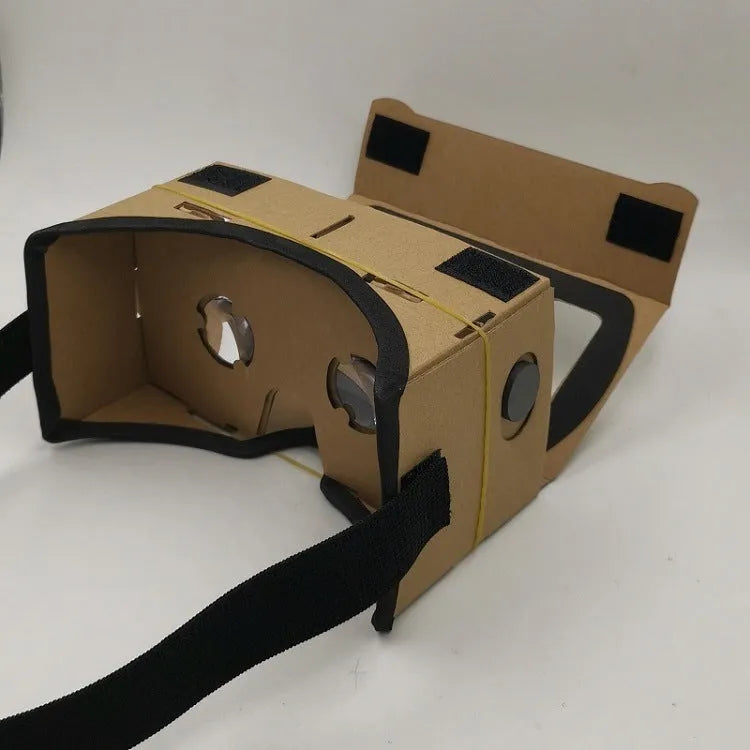 Flat-pack DIY VR cardboard glasses kit for 6-inch smartphones with 3D lenses, rubber band, and velcro strap.