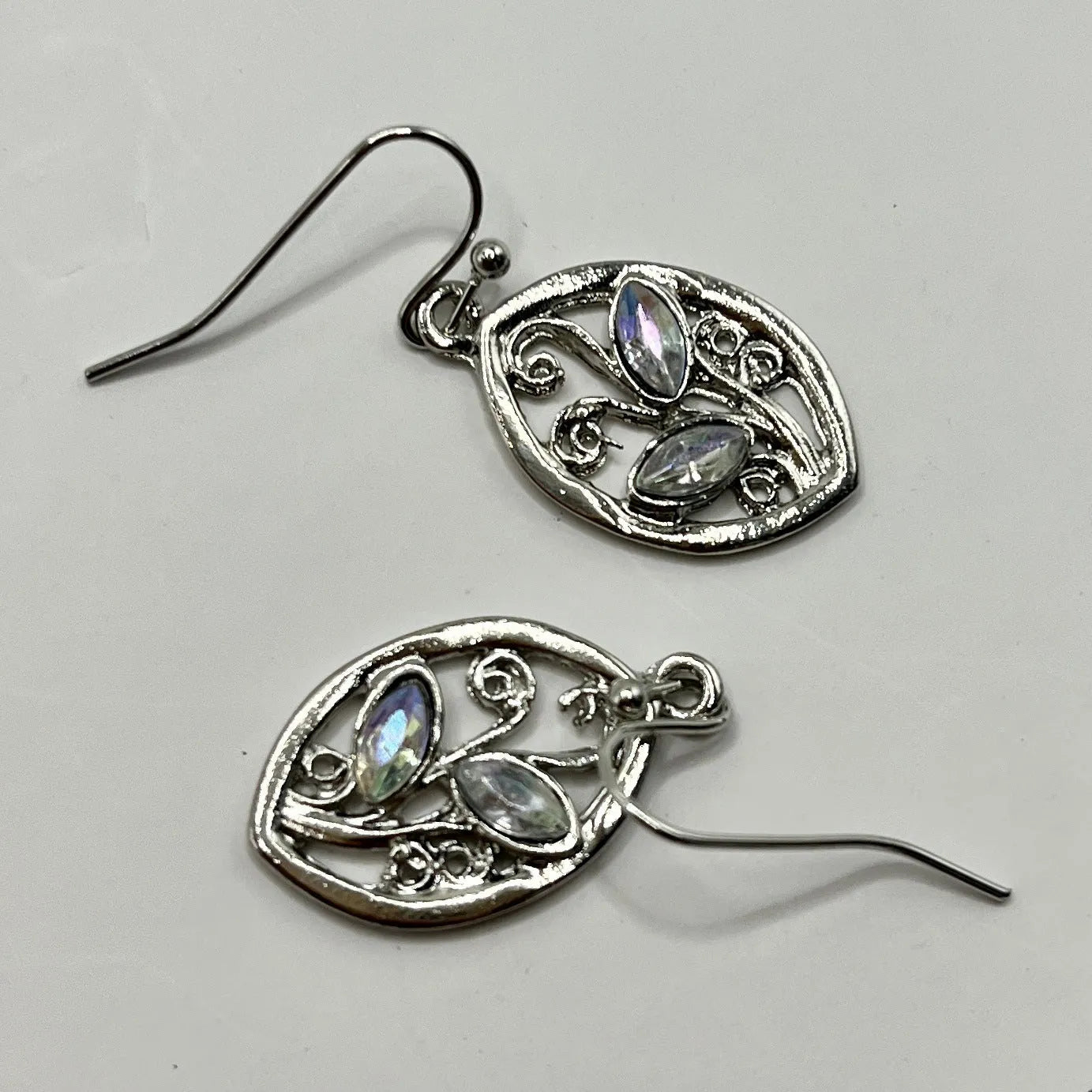Silver leaf-shaped earrings with embedded colourful moonstones on alloy stud backs