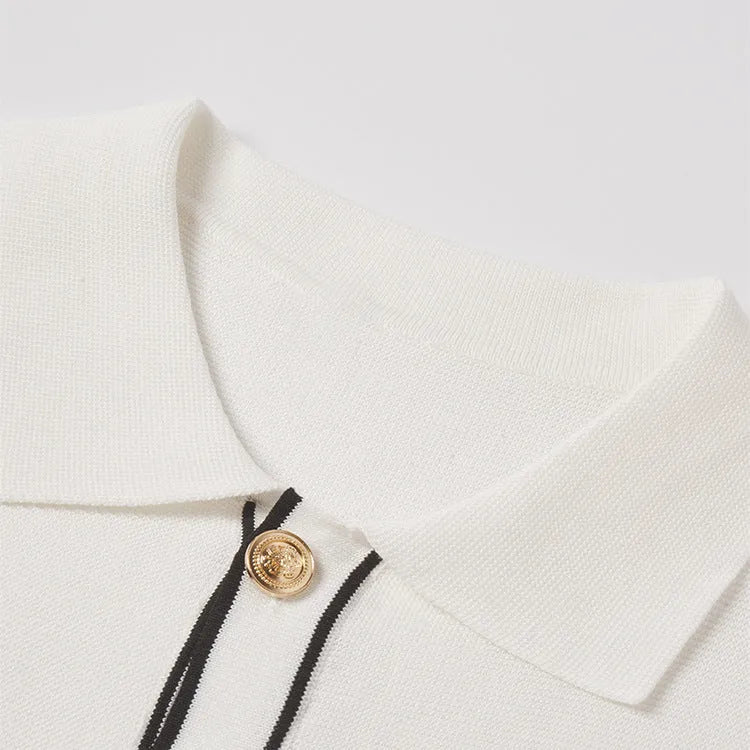 White short sleeve cardigan with dark contrast lapels on a hanger