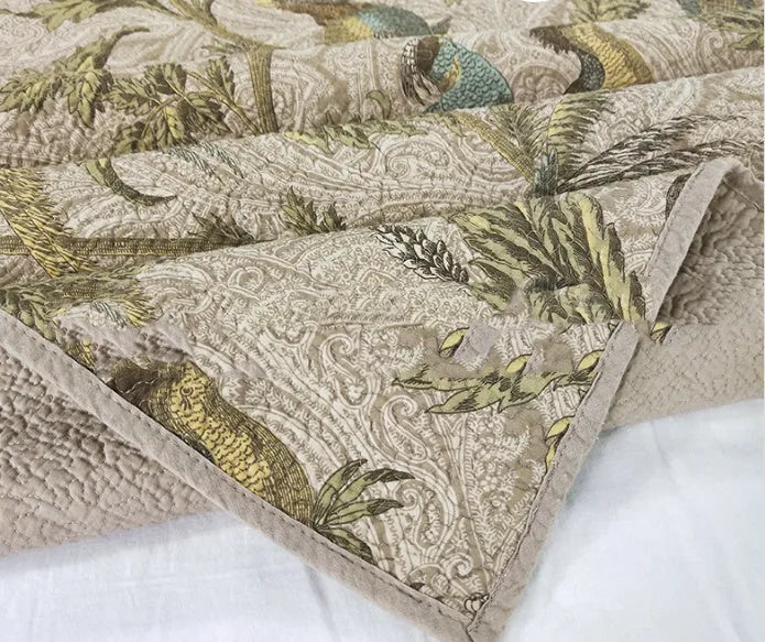 Blue cotton bedspread with floral and bird pattern, part of a 3-piece quilted bedding set.