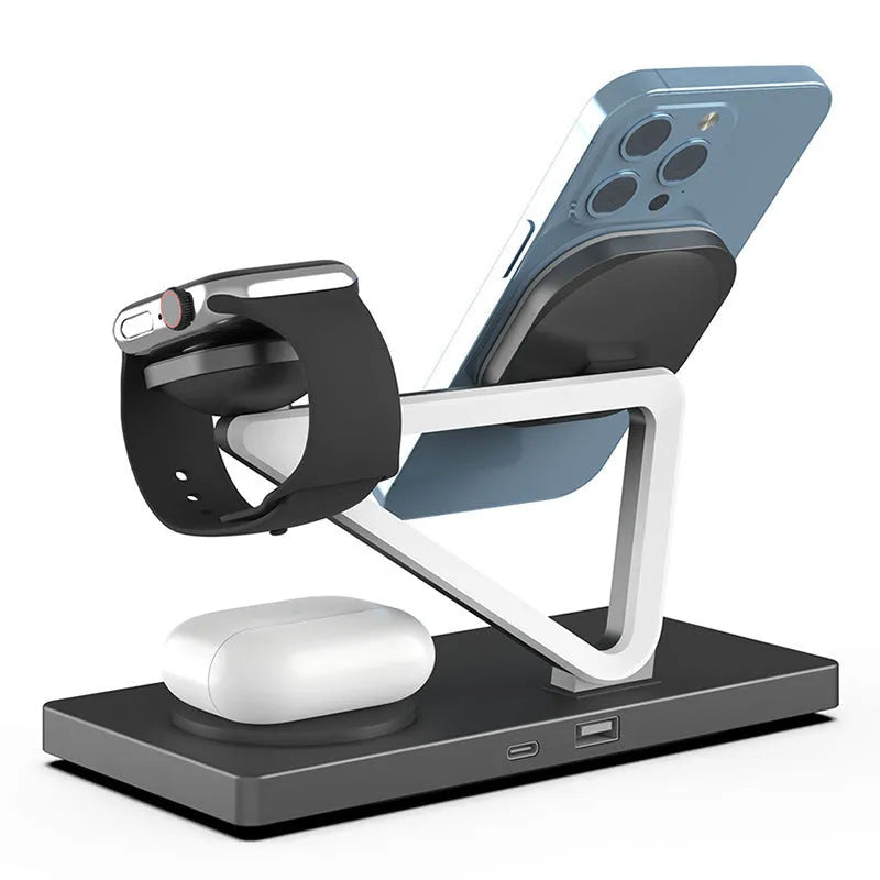 White 5-in-1 wireless charging station with magnetic phone holder, smartwatch pad, and glowing RGB night light on a wooden desk.
