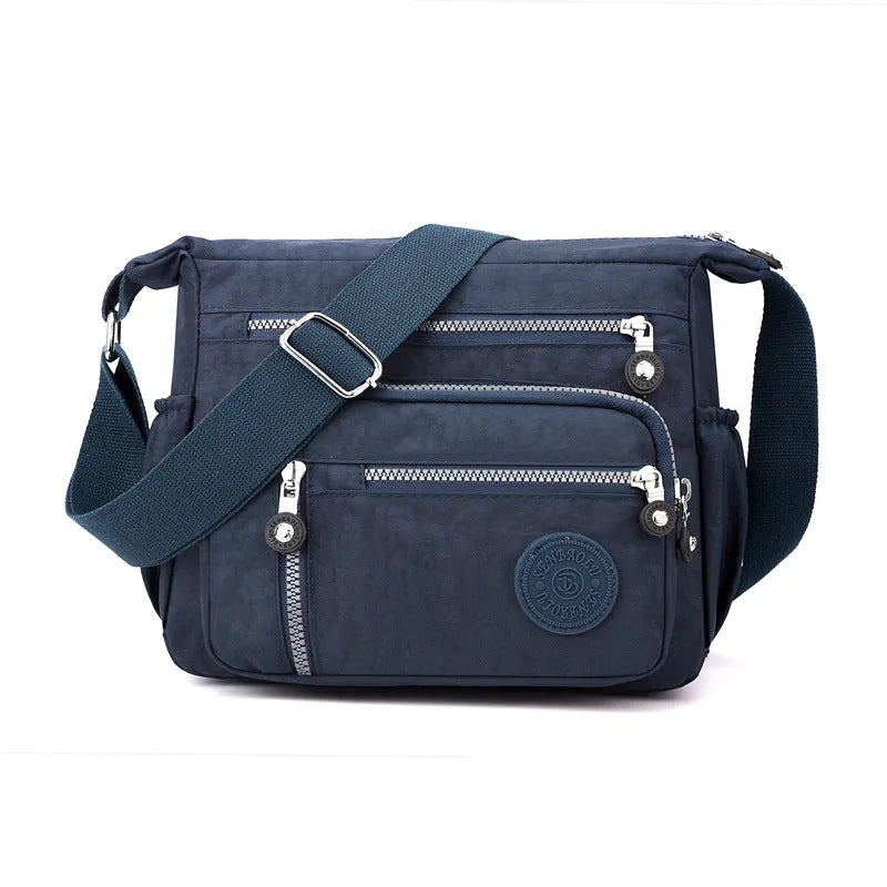 Soft nylon messenger bag in grey, shown as a square vertical model with a single shoulder strap.