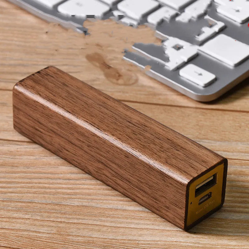Brown walnut wood portable power bank with dimensions 100mm by 25mm.