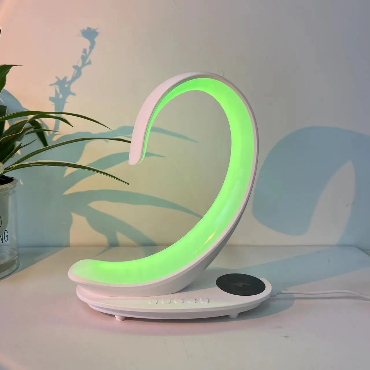 White swan-shaped desktop wireless charger with Bluetooth speaker and colourful atmosphere light