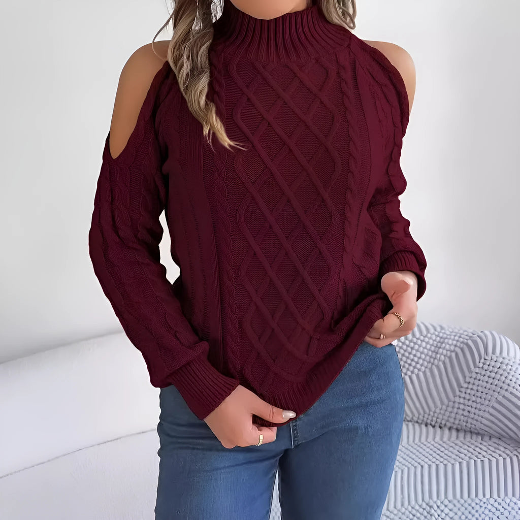 Woman wearing a gray twisted pattern sweater with a strapless half-high collar and long lantern sleeves.