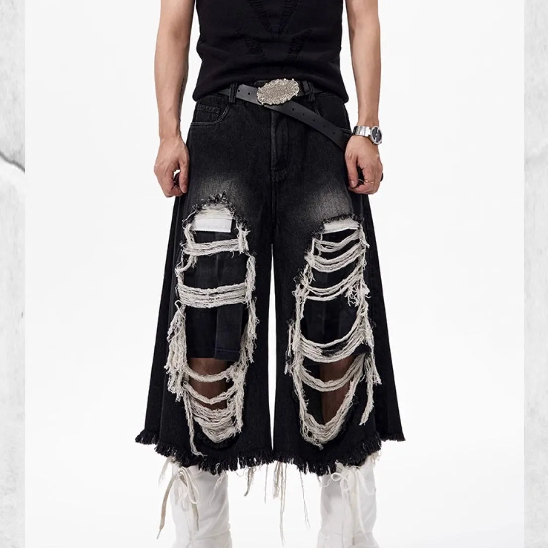 Black cropped wide-leg jeans with mid-high waist and ripped patch details on cotton denim fabric