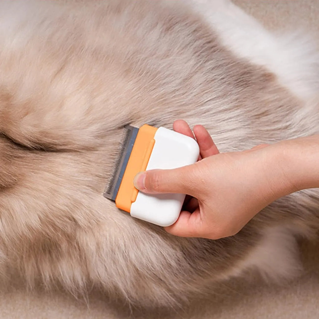 Blue double-sided pet grooming comb for deshedding and massage on cats and dogs.