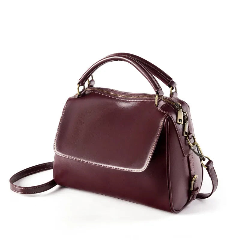 Women's genuine leather crossbody tote bag in apricot colour with double straps and outer slit pocket.