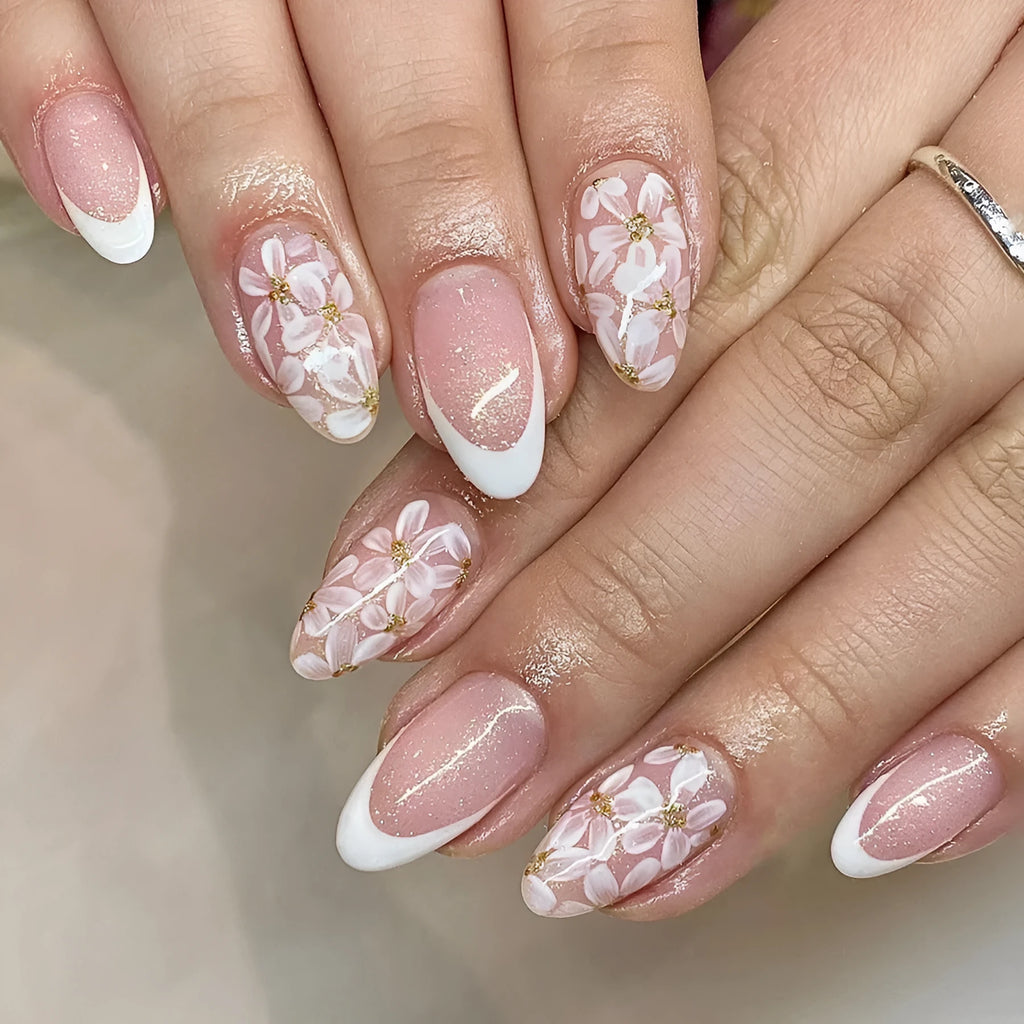 Short glossy almond French artificial nails with glittering powder flower decoration
