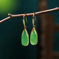 A pair of jade green retro Chinese-style geometric earrings with water droplet details.