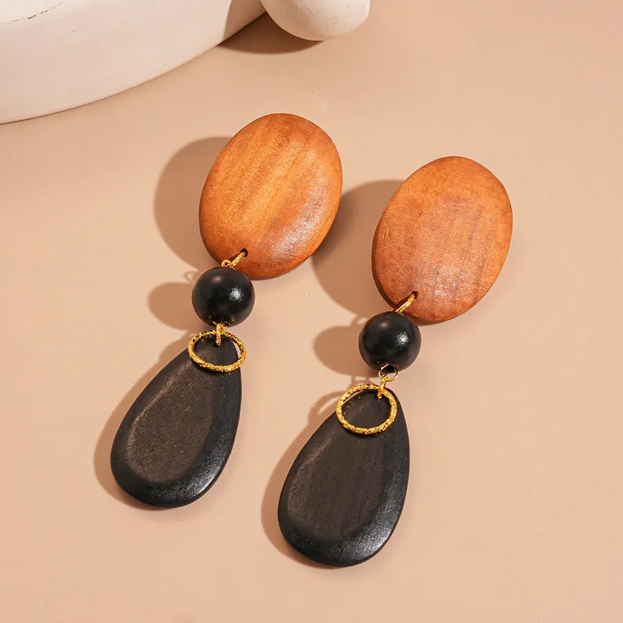 Wooden earrings with elliptical design in silver needle-brown-black colour scheme