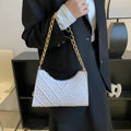 Brown pleated chain baguette women's shoulder bag with adjustable strap on a mannequin.