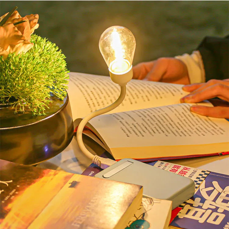 Folding USB rechargeable night light with warm white tungsten bulb, shown in open position.