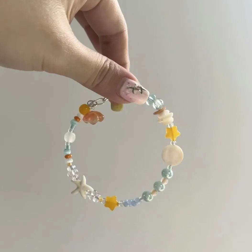 Mixed material alloy bracelet with diamond elements and round detailing in Orange Sea Summer colour