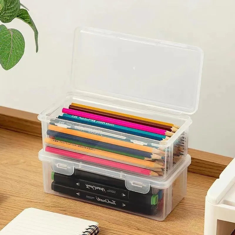 Transparent plastic stationery storage box containing pencils and coloured art supplies