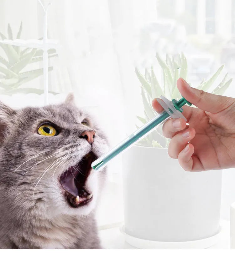 Two silicone pet pill shooter syringes with soft tips on a white background
