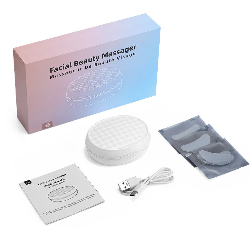 White wireless red light eye and facial massager with EMS technology held in hand
