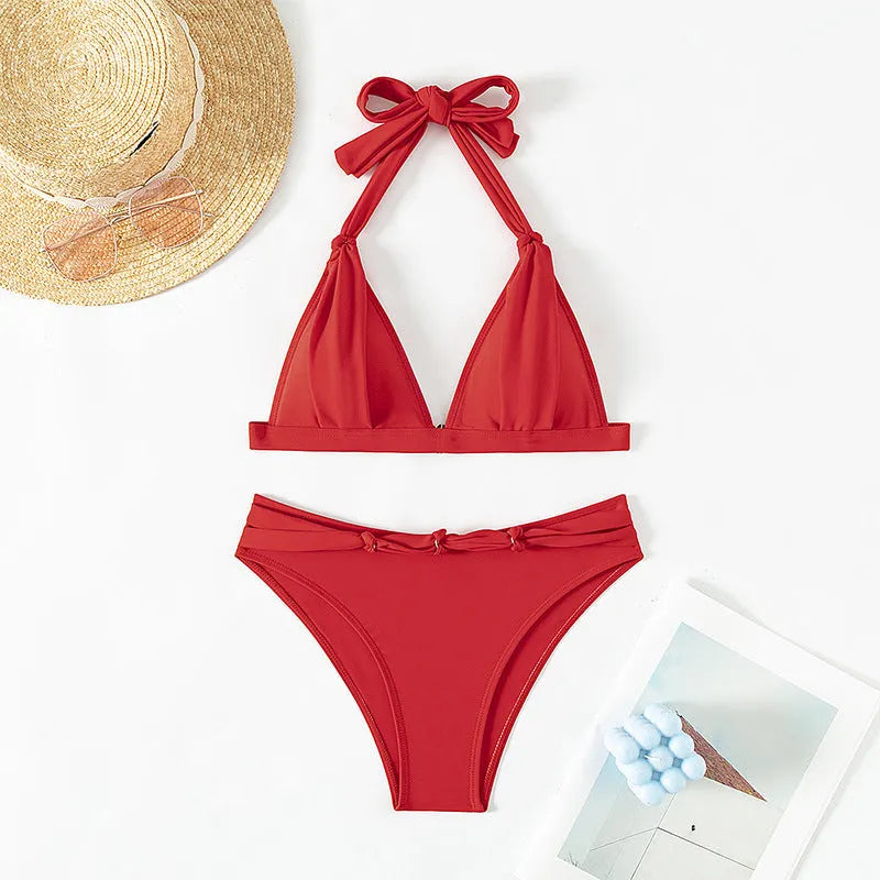 Red women's halterneck lace-up bikini top and shorts set on a mannequin.