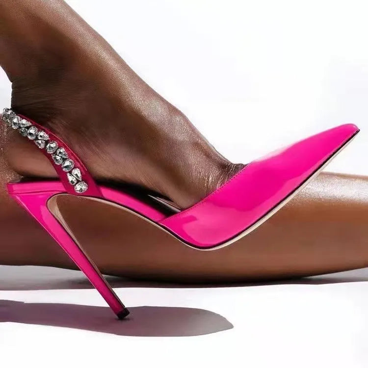 Black patent leather women's high heel sandals with pointed toes and side rhinestone straps.
