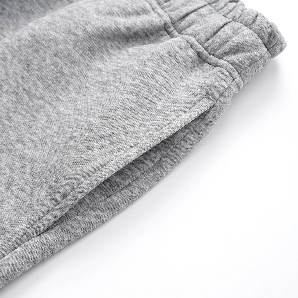 Men's grey cotton straight-leg loose fit trousers with an elasticated waistband on a neutral background.
