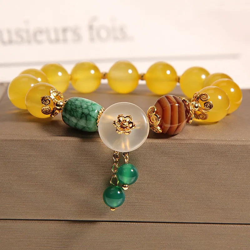 Khaki coloured crystal bead bracelet for women on a gold silk cord, showing Japanese and South Korean style.