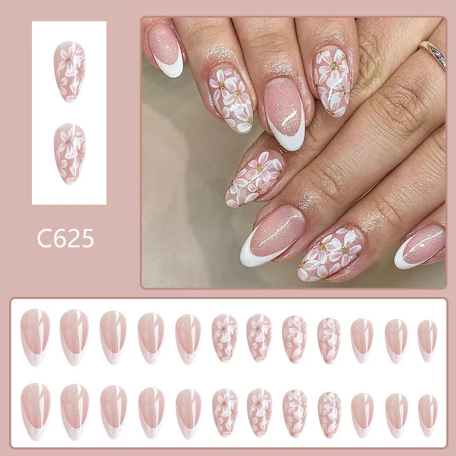 Short glossy almond French artificial nails with glittering powder flower decoration
