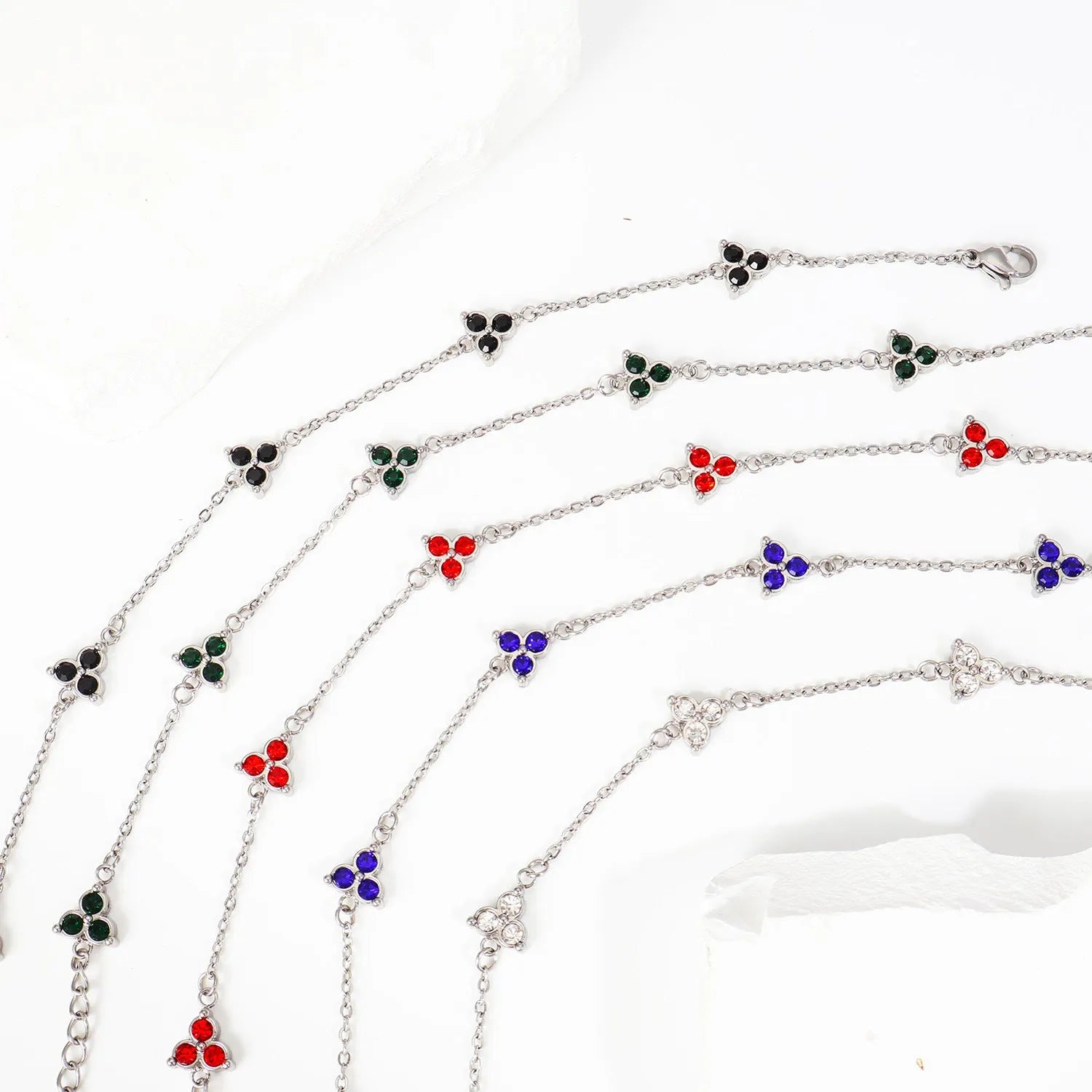 Women's geometric stainless steel bracelet with triple diamond design and coloured stone in gold or steel tone.