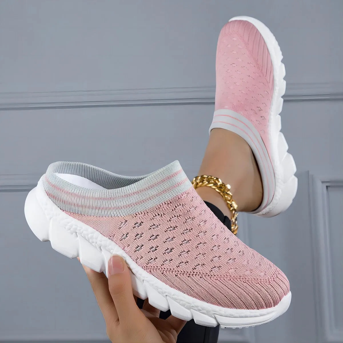 Women's black Flyknit socks semi slipper shoes with striped pattern and hollow-out design on a viscose sole.