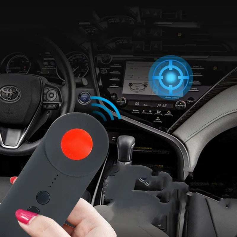 Black portable GPS and WiFi signal detector with laser scanner for hidden cameras on a table.