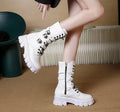 Women's black mid-calf boots with side zip and metal buckle detail on a white background.